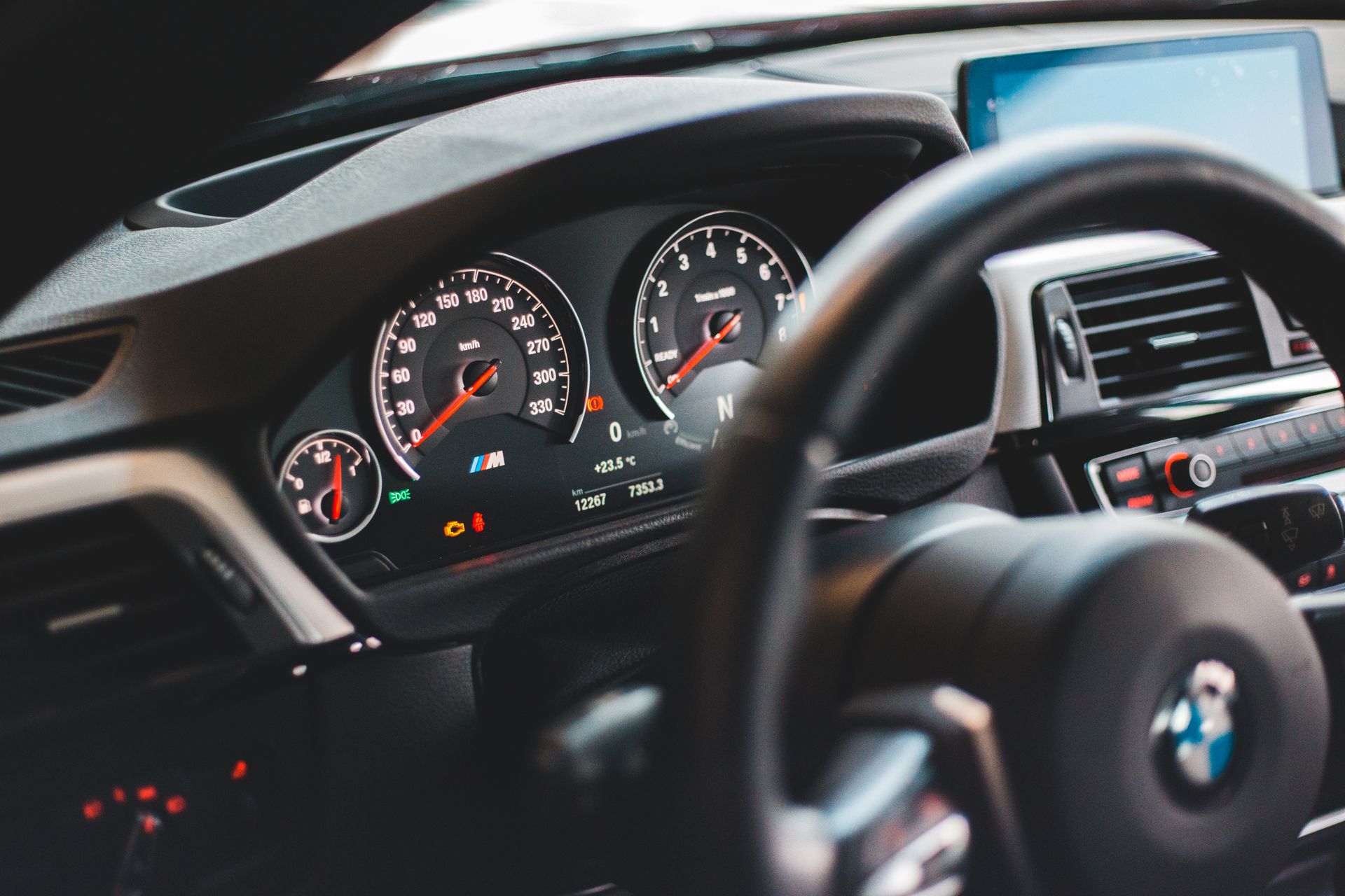 Close-up view of a luxury car dashboard showcasing modern design and digital displays.