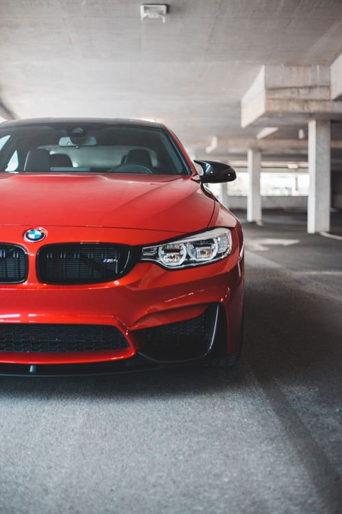 Free New luxury automobile with red rich color and strong bumper inside parking garage Stock Photo