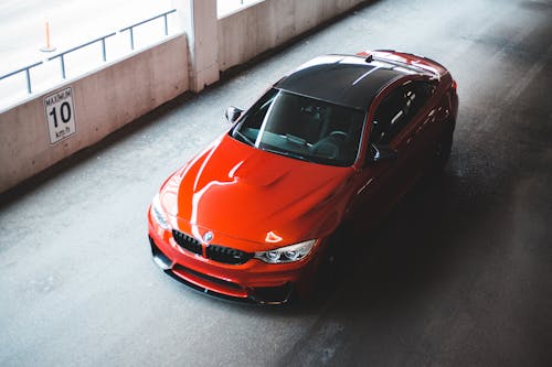 Free From above of sport modern automobile with red and black elements on parking road Stock Photo