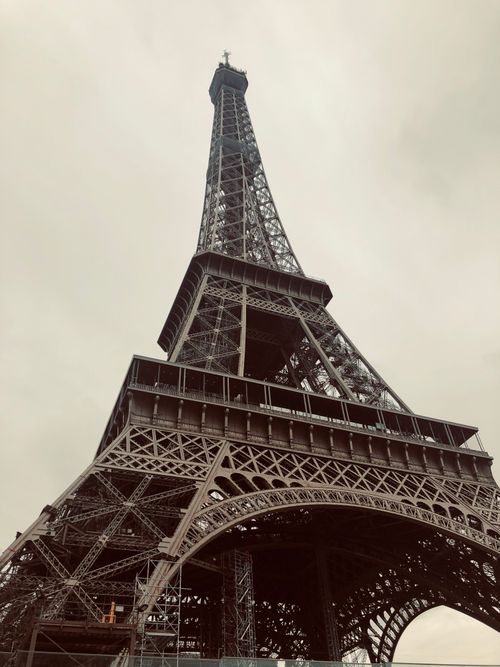Free Low angle view of the Eiffel Tower under a cloudy sky, Paris landmark. Stock Photo