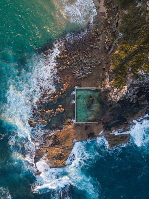 Aerial Footage of Waves Crashing on Rocky Shore