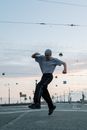 Man in White T-shirt and Black Pants Jumping on Mid Air