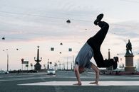 Man in Black T-shirt and Blue Shorts Running on Street