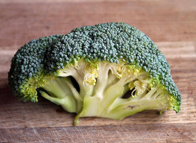 Green Broccoli Vegetable On Brown Wooden Table