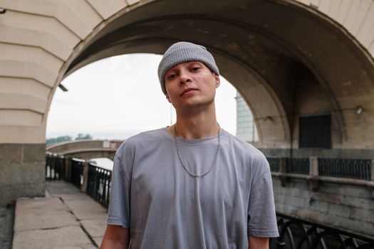 Man in Gray Crew Neck T-shirt Standing on Gray Concrete Pavement