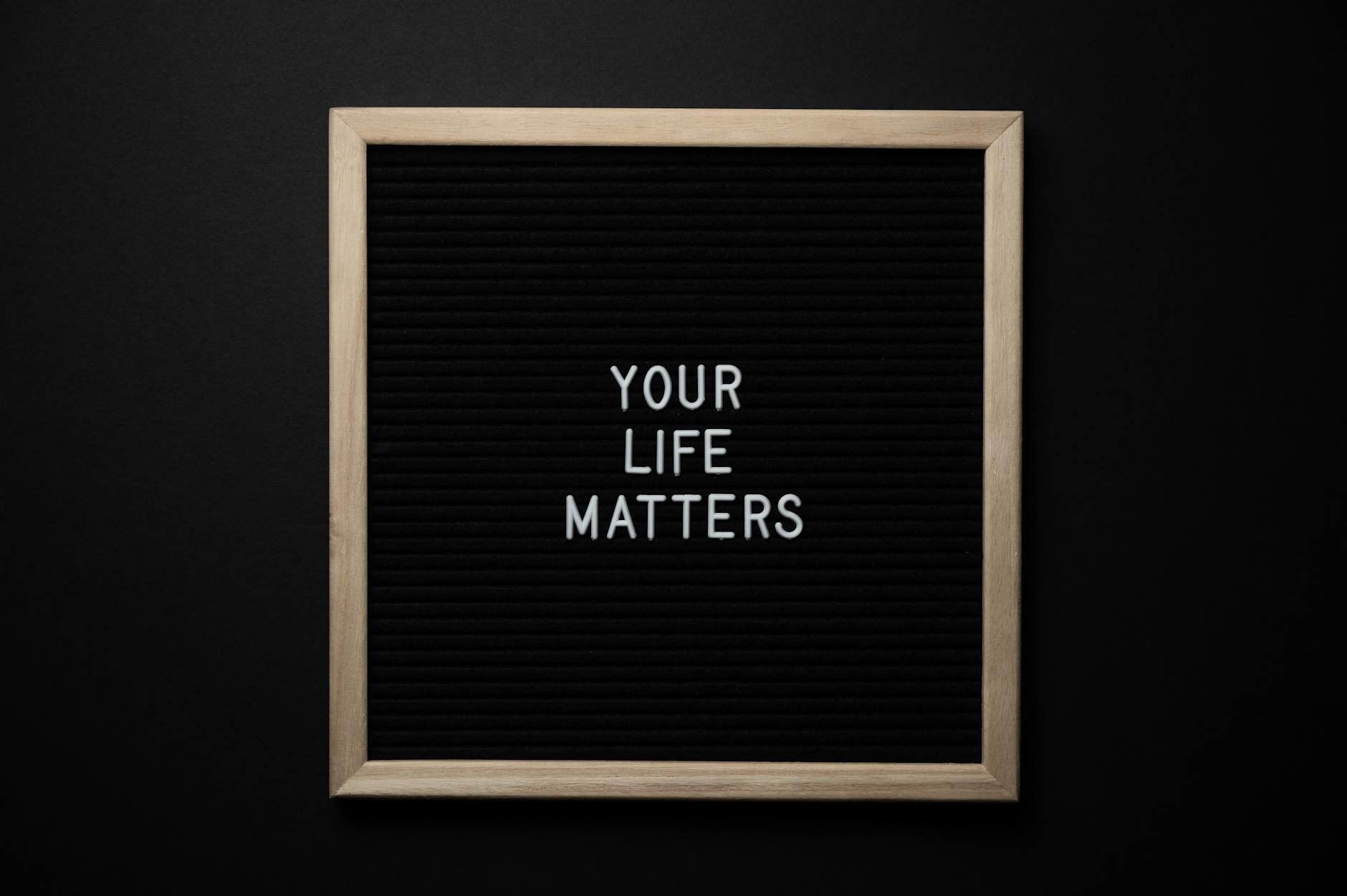Blackboard with YOUR LIFE MATTERS inscription on black background