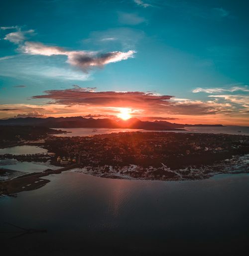 Free High view of peninsula with town surrounded water against mountains at colorful sunset Stock Photo