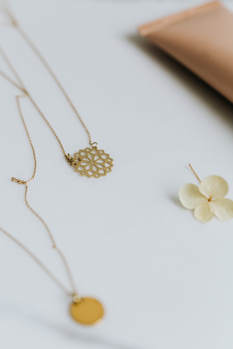 A Floral Design Pendant Necklace On White Table