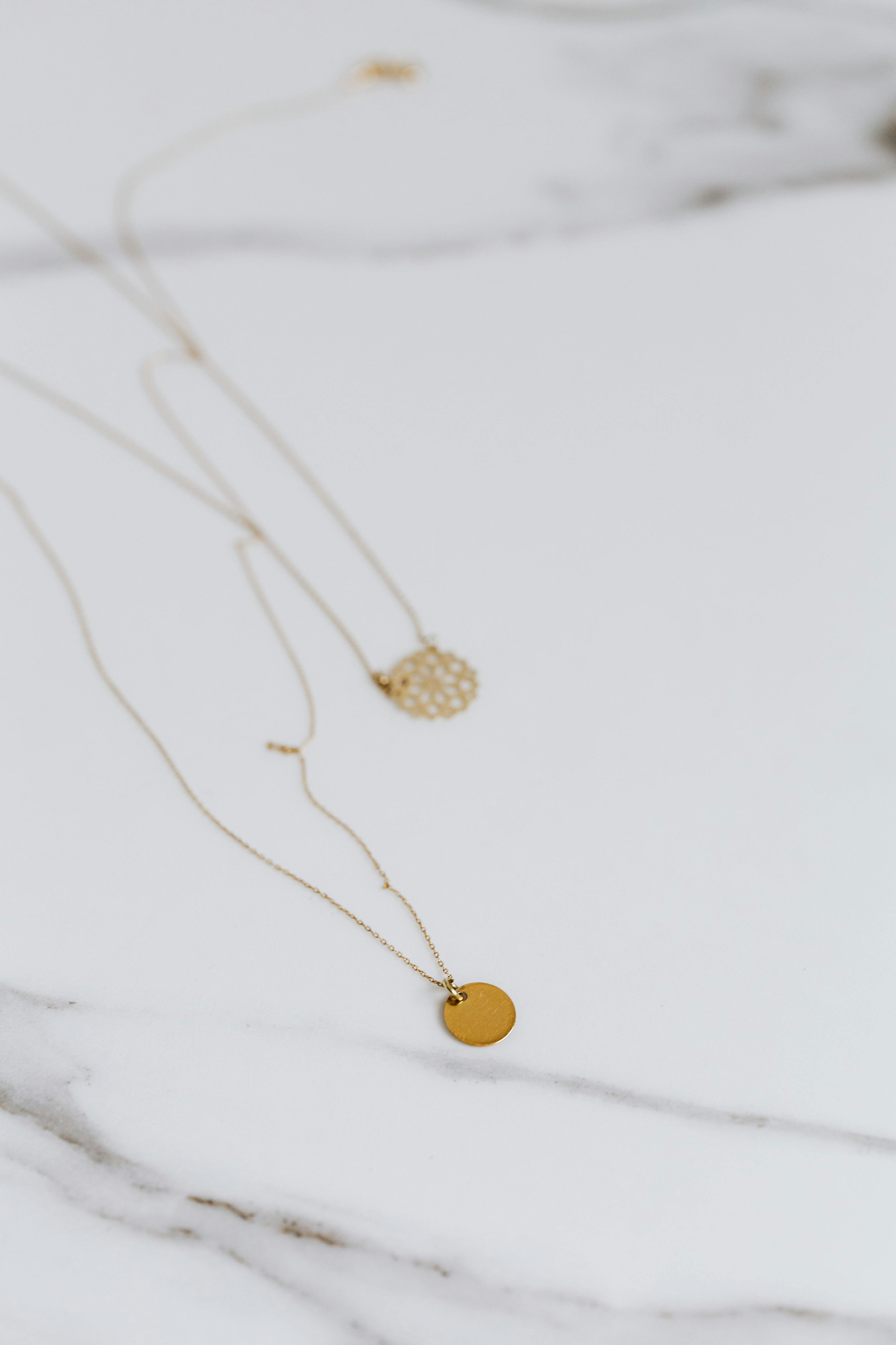 gold round pendant on necklace