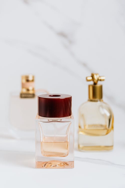 Free Clear Glass Perfume Bottle with Red Lid Stock Photo