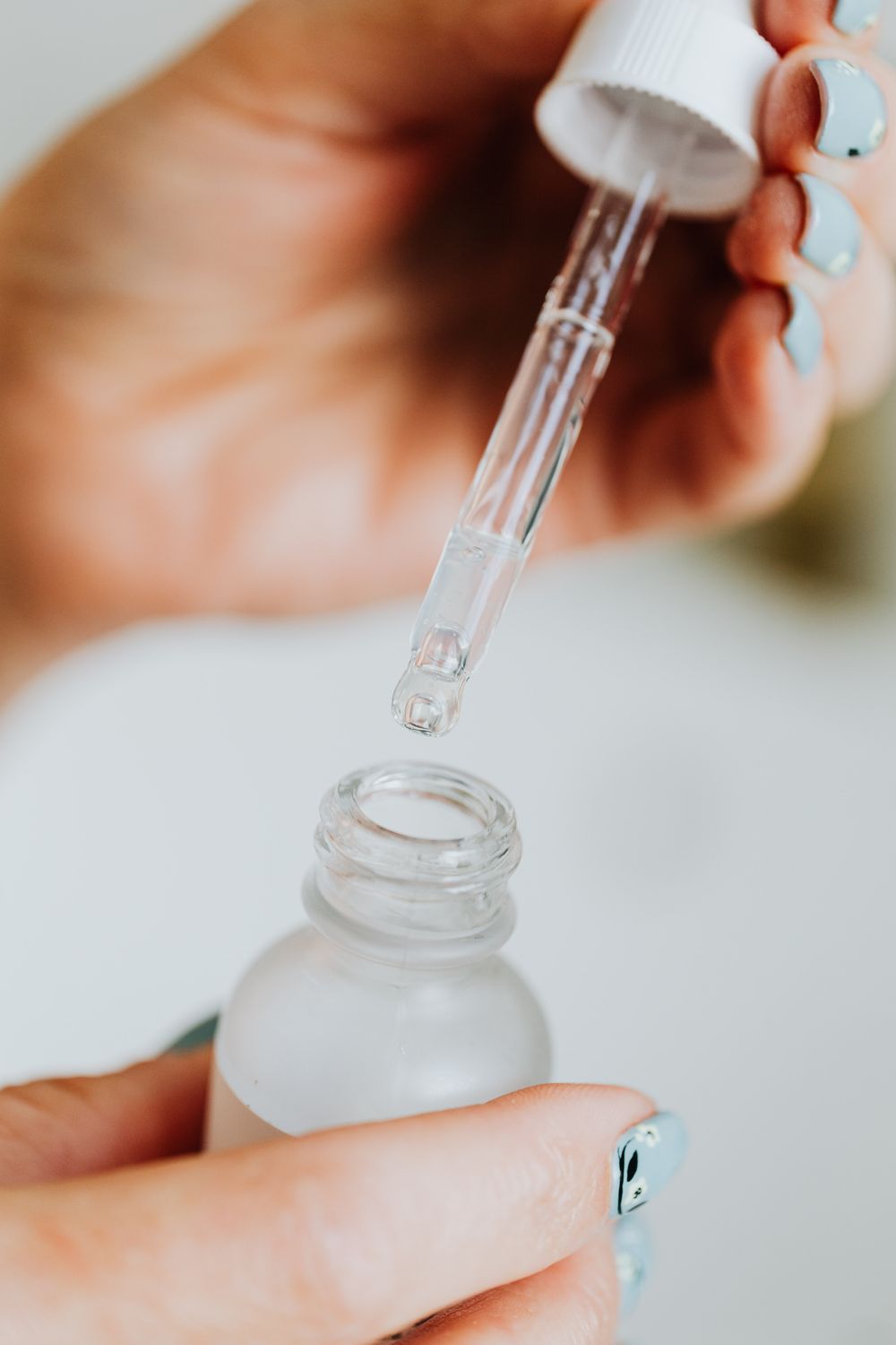 Clear skincare serum dropper in a close-up beauty ritual