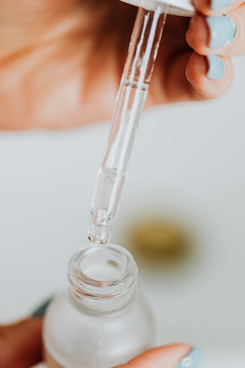 Free Pipette over Bottle of Serum Stock Photo