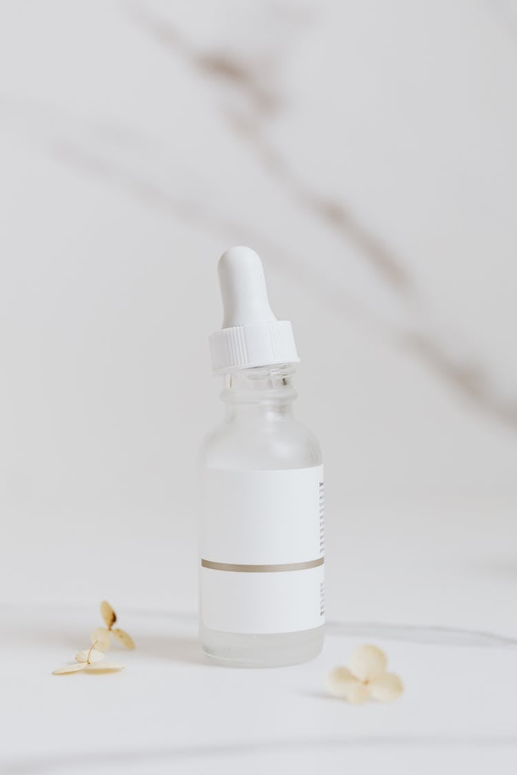 White Serum Bottle On White Surface 