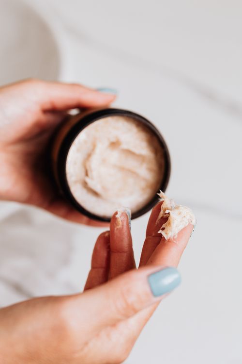 Free Hands applying skincare cream from a jar, perfect for beauty and cosmetics themes. Stock Photo