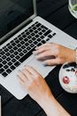 Person Using Macbook Pro on Black Table