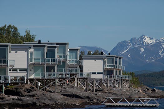 Contemporary lakeside cabins with stunning mountain backdrop, perfect for serenity seekers.