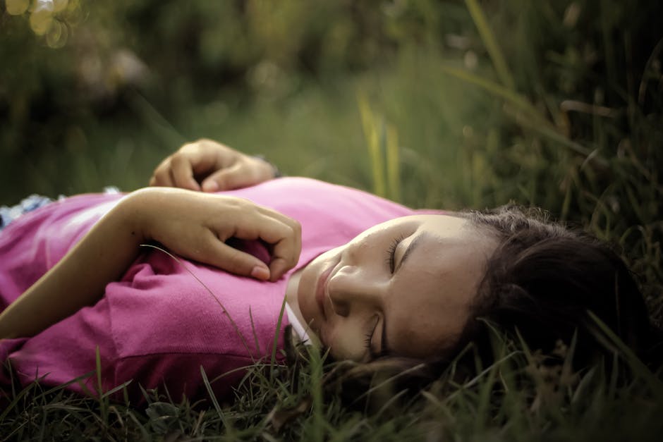 Woman Lying on Green Grass