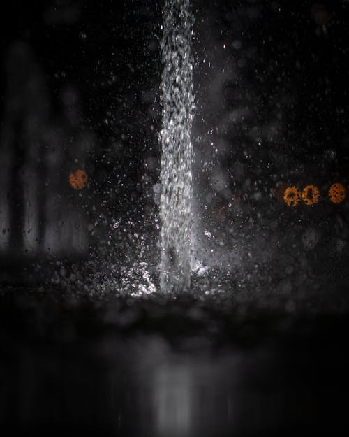 Water pouring and splashing in darkness