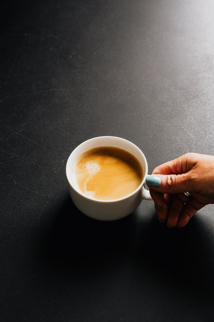 Woman Holding A Cup Of Coffee With Milk 