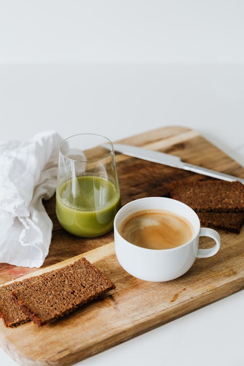 Slice Breads Near a Cup of Coffee