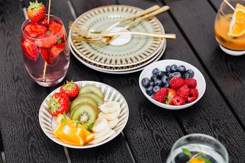 Fruits on Plates and Cocktails on Table