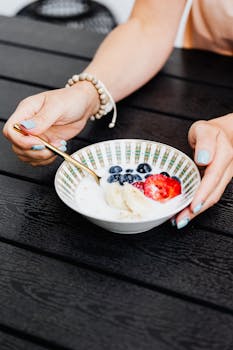 Enjoy a nutritious breakfast with fresh berries and banana slices in a stylish bowl.