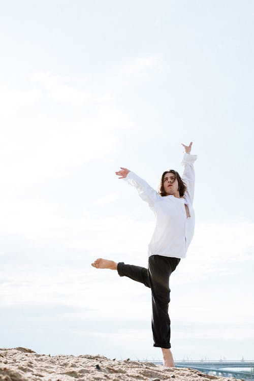 Free Woman in White Long Sleeve Shirt and Black Pants Stock Photo