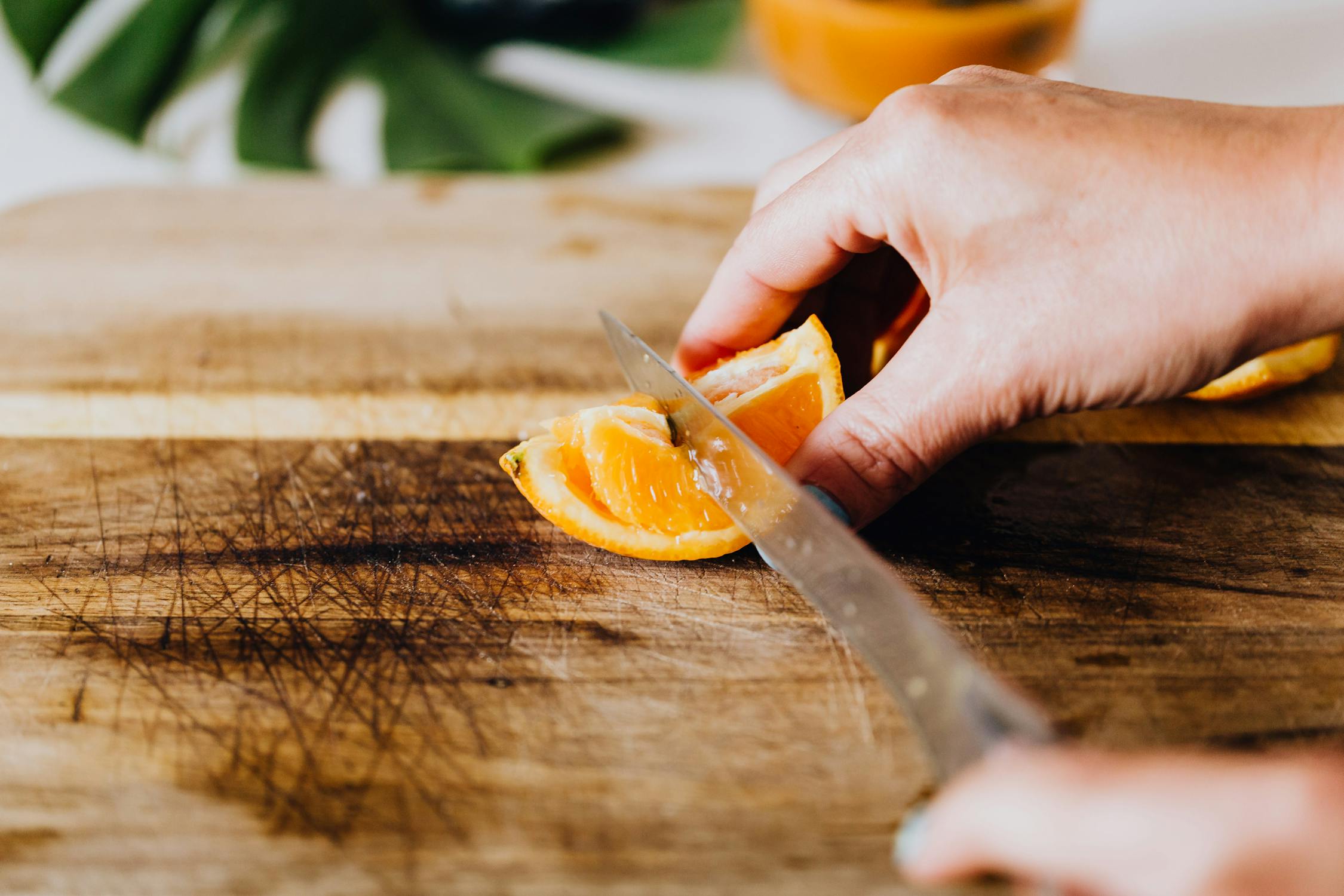 Person Holding Stainless Steel Knife and Sliced Orange Fruit · Free ...