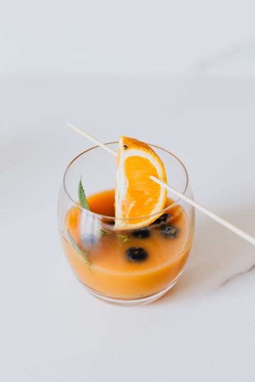 Orange Fruit Hanging on Clear Drinking Glass