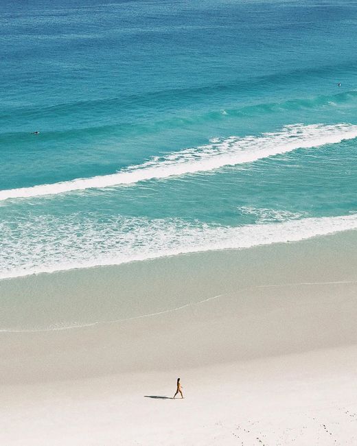 A stunning aerial shot of Arraial do Cabo's pristine coastline with turquoise waters and white sand.