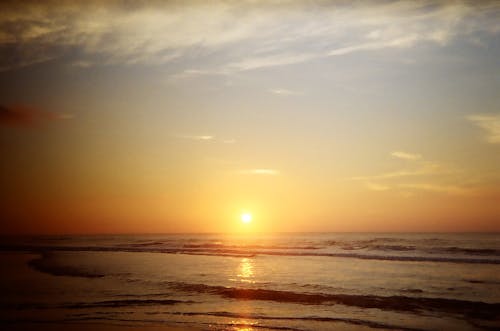 Free Sunset over Sea Shore Stock Photo