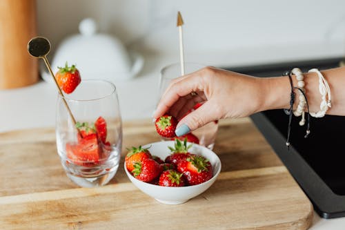 A Person Holding Fresh Strawberry