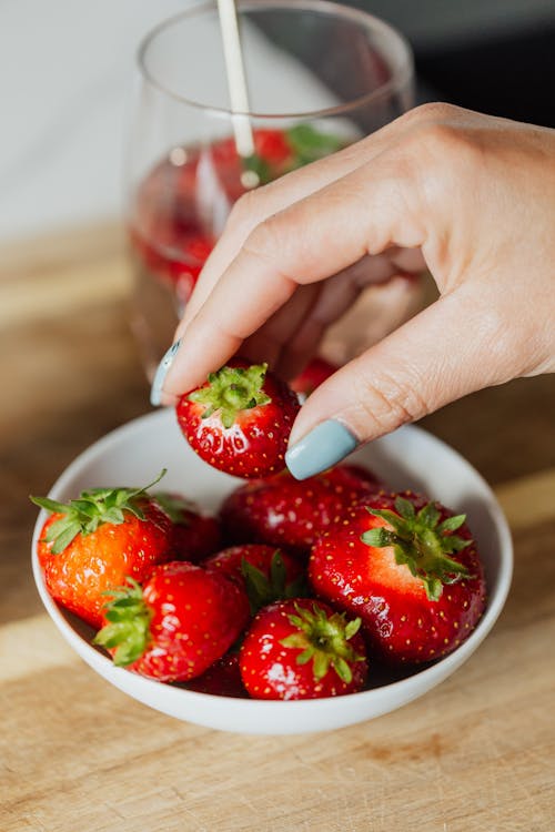 A Person Holding Fresh Strawberry
