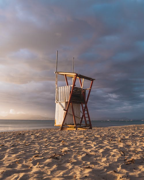 Free Lifeguard Tower on Beach at Sunrise Stock Photo