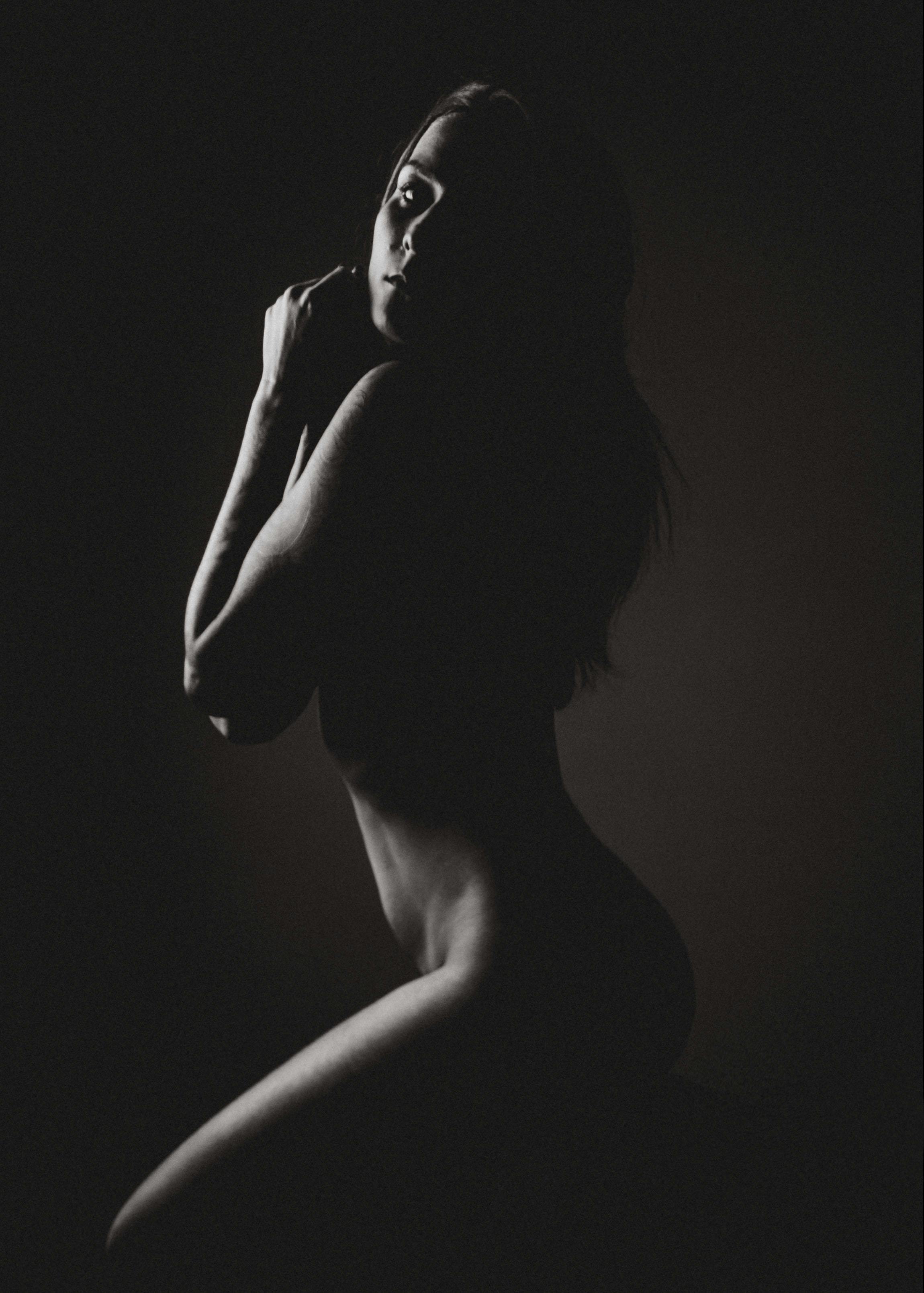 Naked woman in dark studio · Free Stock Photo