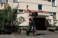 Man in Gray Tank Top Holding Balloons