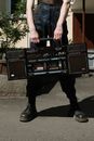 Man in Black Jacket and Black Pants Holding Black and Red Audio Mixer