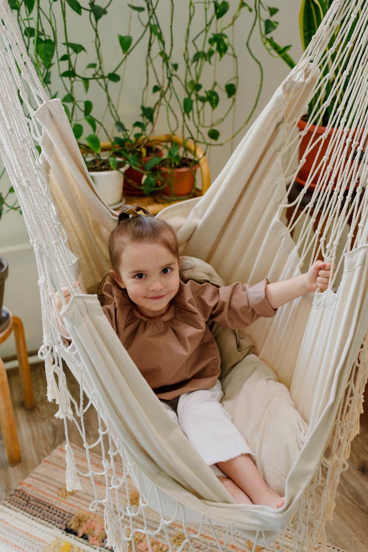 Smiling Girl In Comfortable Hammock At Home