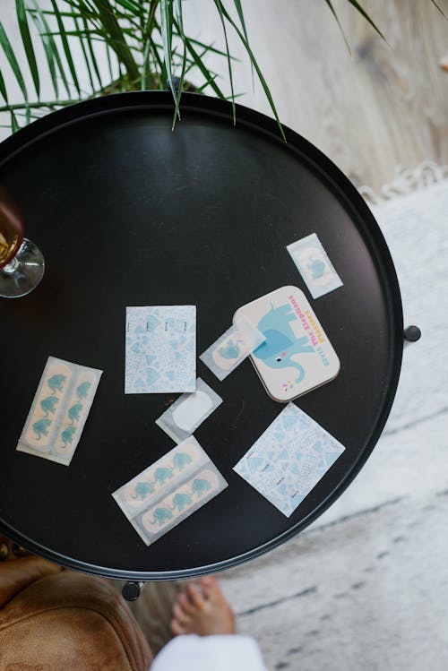 Various adhesive sticking plasters on round table in stylish room