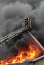 Man in Black Jacket Standing on Black Metal Tower