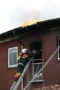 Firefighter on Ladder Putting out Fire