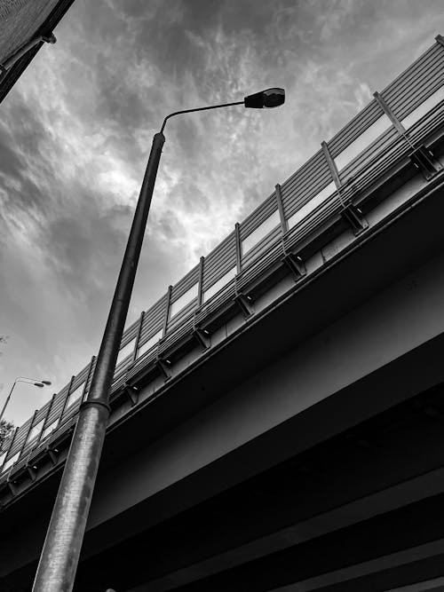 Free Grayscale Photo of Street Light Under Cloudy Sky Stock Photo