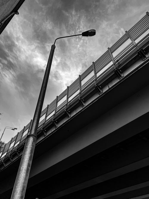 Free Dramatic black and white shot of streetlight and overpass, vertical perspective. Stock Photo