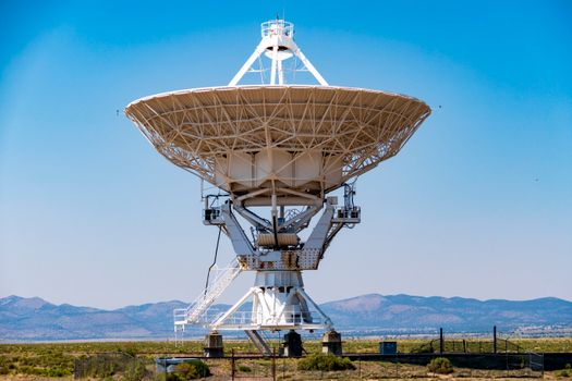 White Satellite Dish on Green Grass Field Under Blue Sky