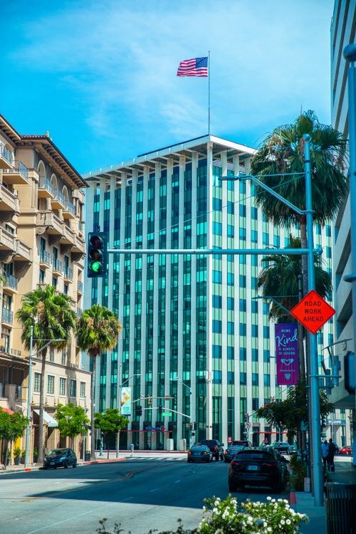 Free Vibrant cityscape of Los Angeles featuring modern architecture and an American flag. Stock Photo