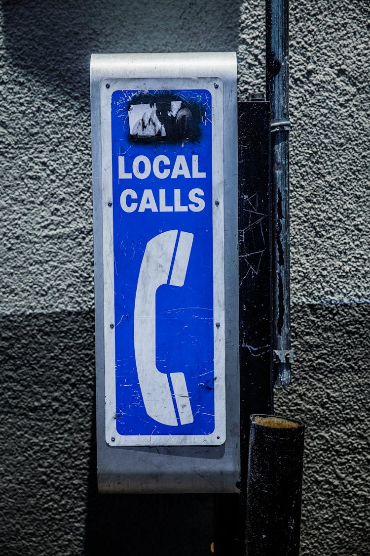 Public Telephone Booth On Street Sidewalk