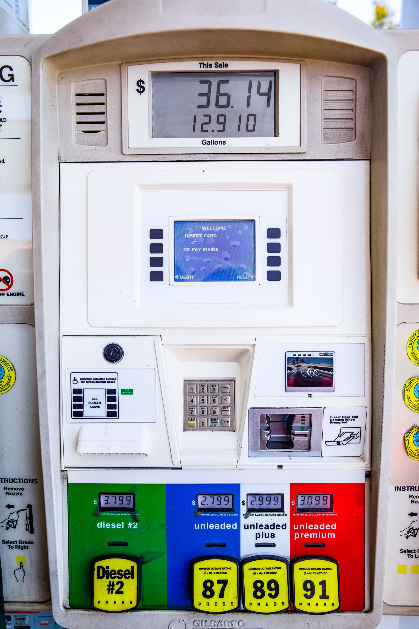 Dispenser face showing the price and volume display, payment terminal, keypad and grade selection buttons.