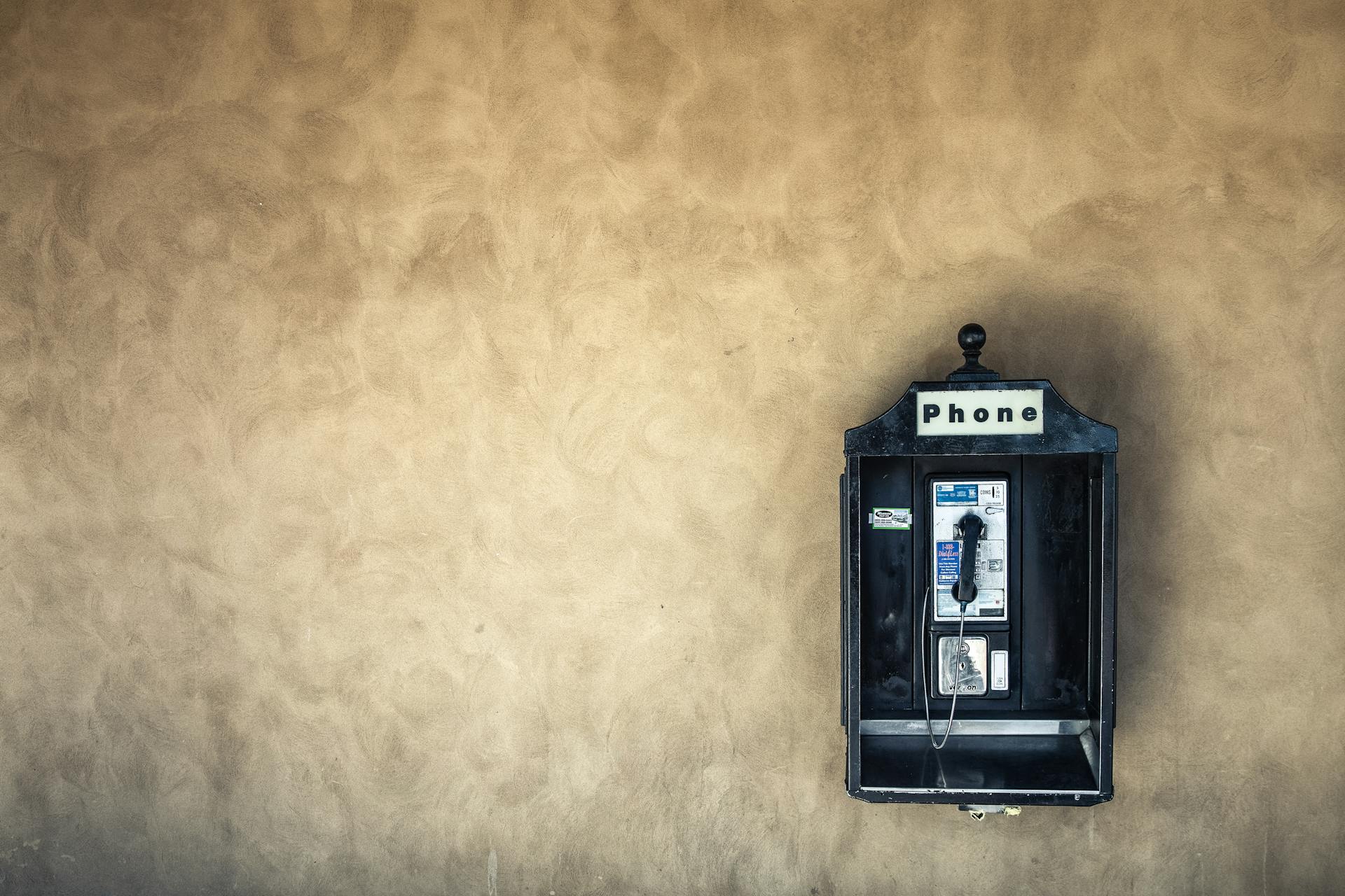 Vintage Public Telephone on Concrete Wall