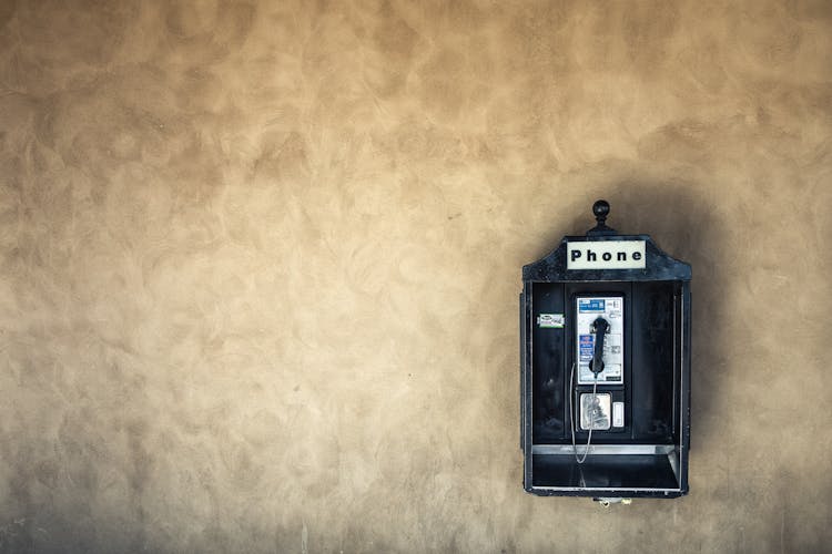 Vintage Public Telephone On Concrete Wall