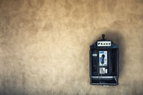 Free Classic payphone on a textured wall in Santa Barbara, ideal for vintage themes. Stock Photo